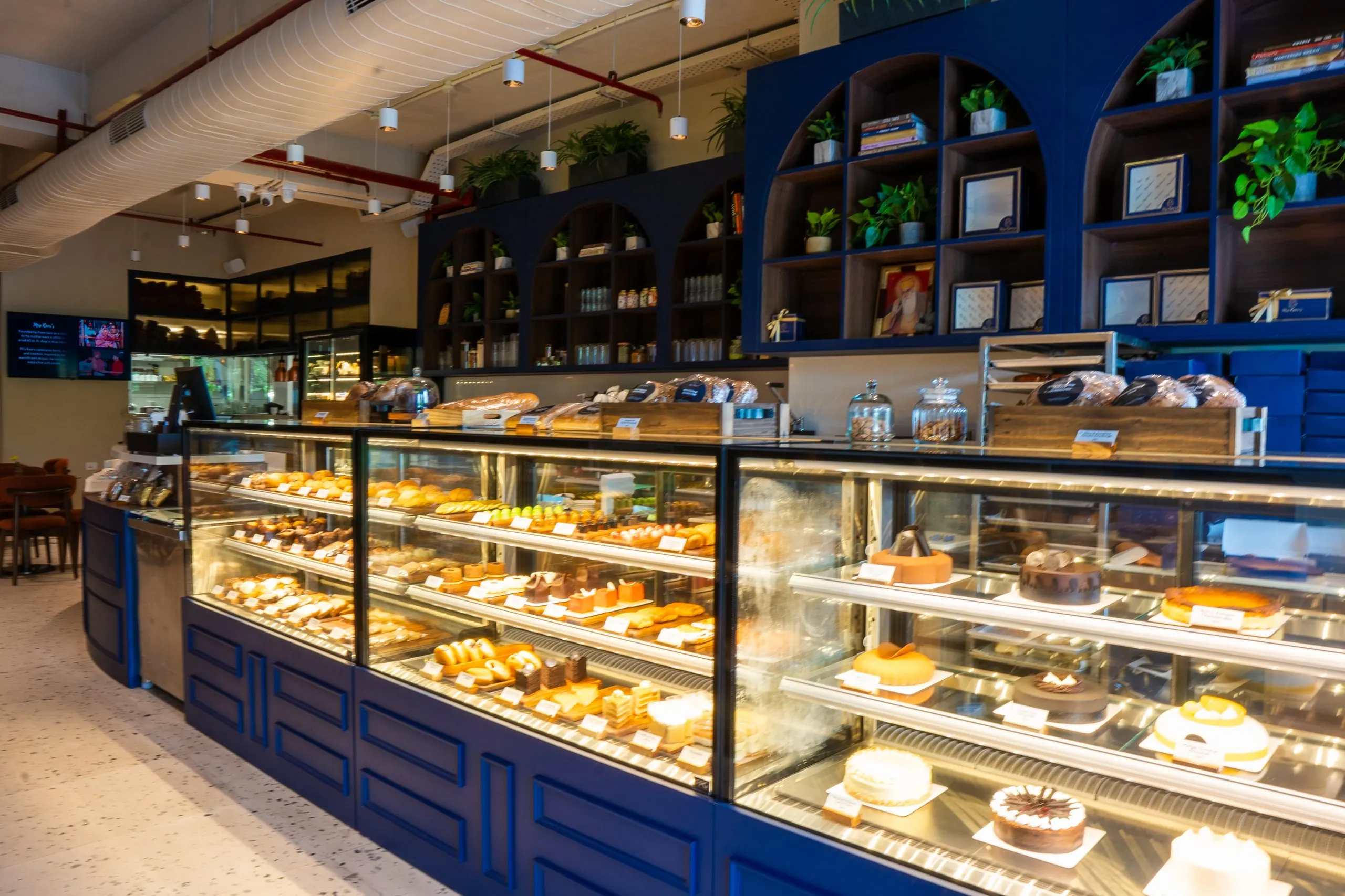 The bakery counter at Mrs Kaur's, Golf Course Road: glass cases of breads and cakes under navy shelving
