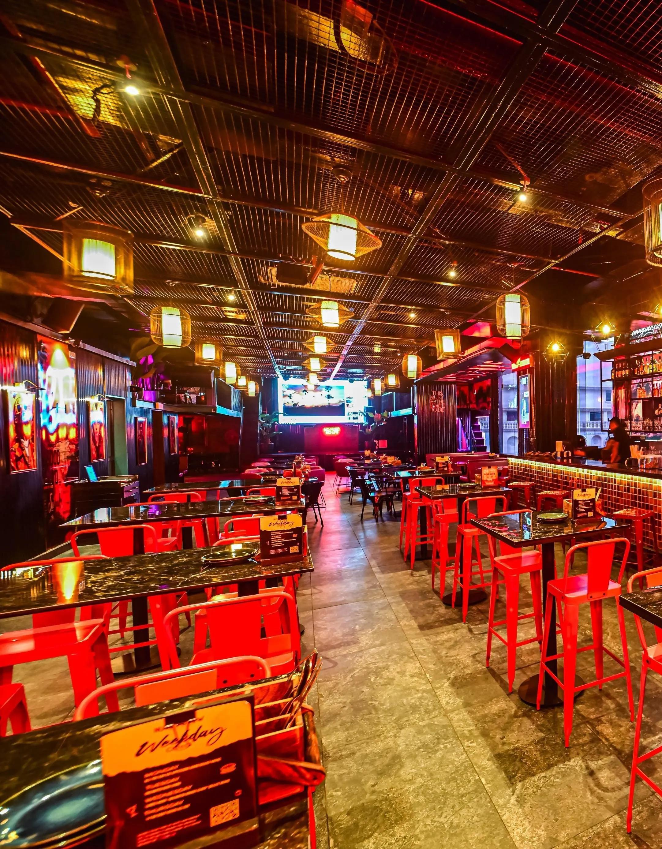 Rows of red high stools and stone-topped tables running the length of the Nuts & Brew hall